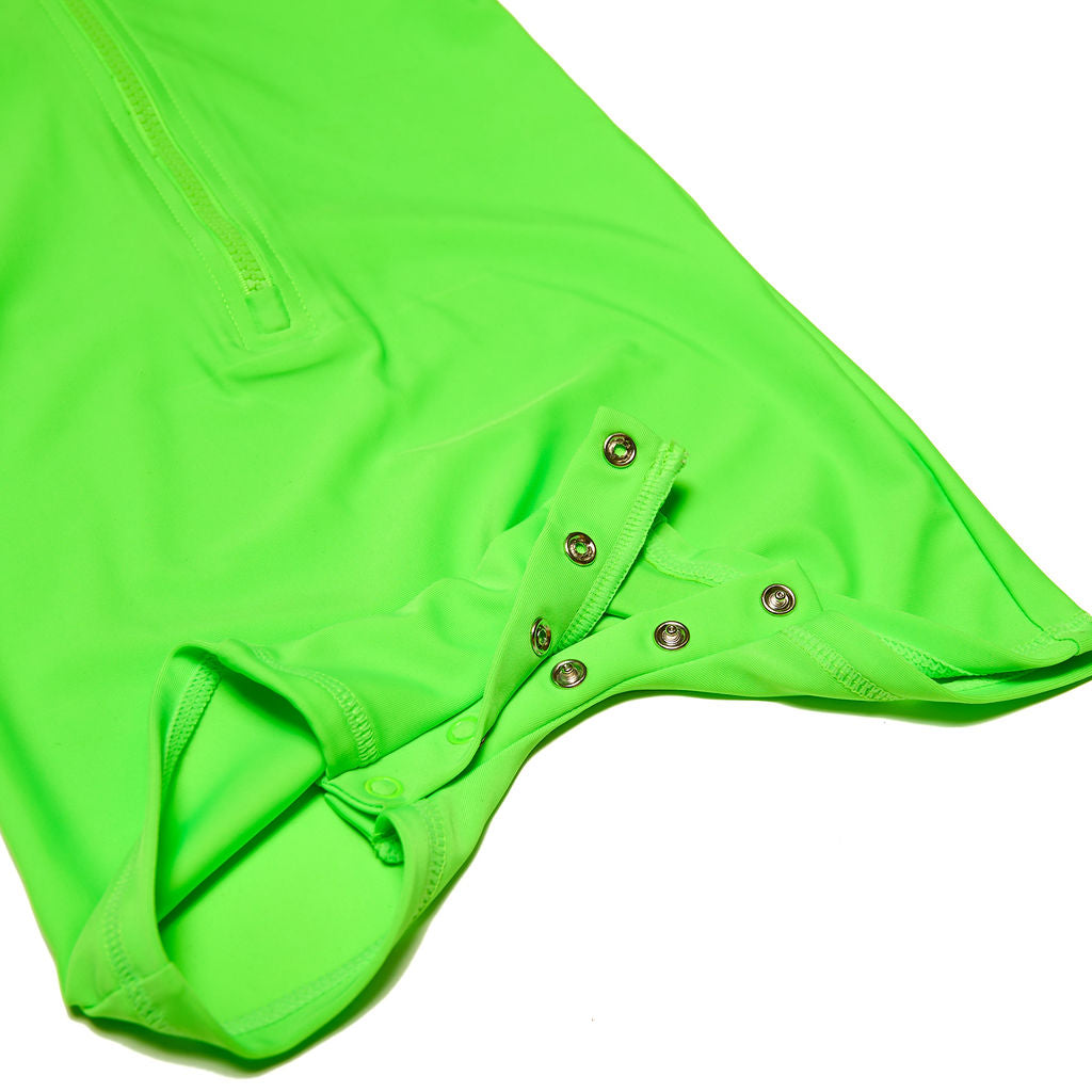 Close up of neon green and neon orange children's rash guard one piece. Focus is on snaps for easy diaper changes.